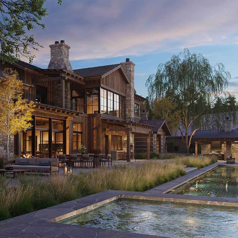 Exterior of a modern passive house showcasing large south-facing windows, natural stone walls for thermal mass, and shaded outdoor spaces for passive cooling.